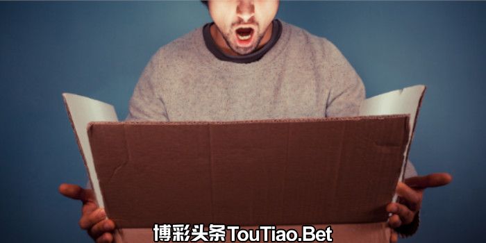 A surprised young man holding an opened box