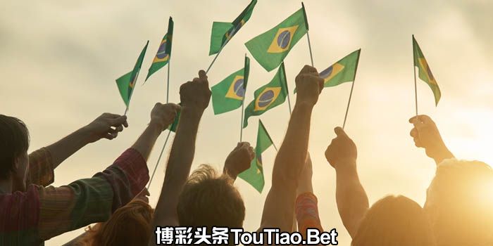 People waving multiple Brazilian flags